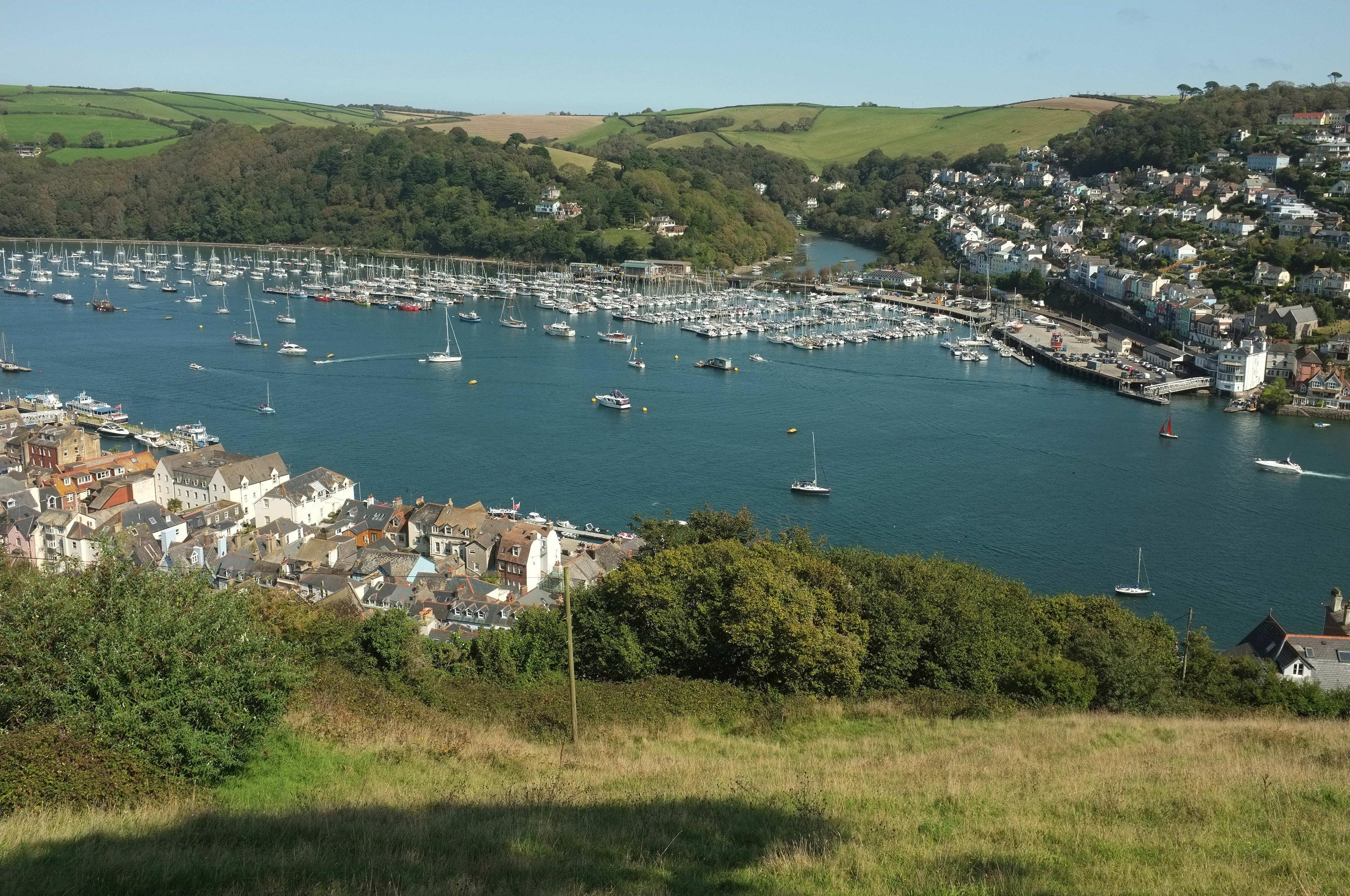 Real view over the River Dart at Dartmouth, with the waterfront settlement, river access and wooded countryside.